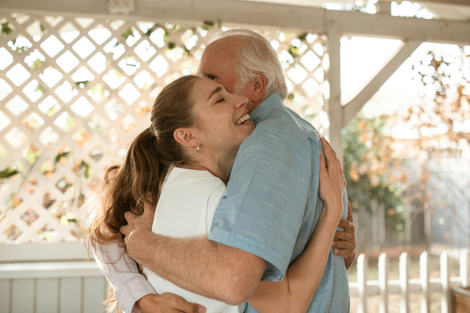 Joyful moment captured as family members share a heartfelt hug outdoors.